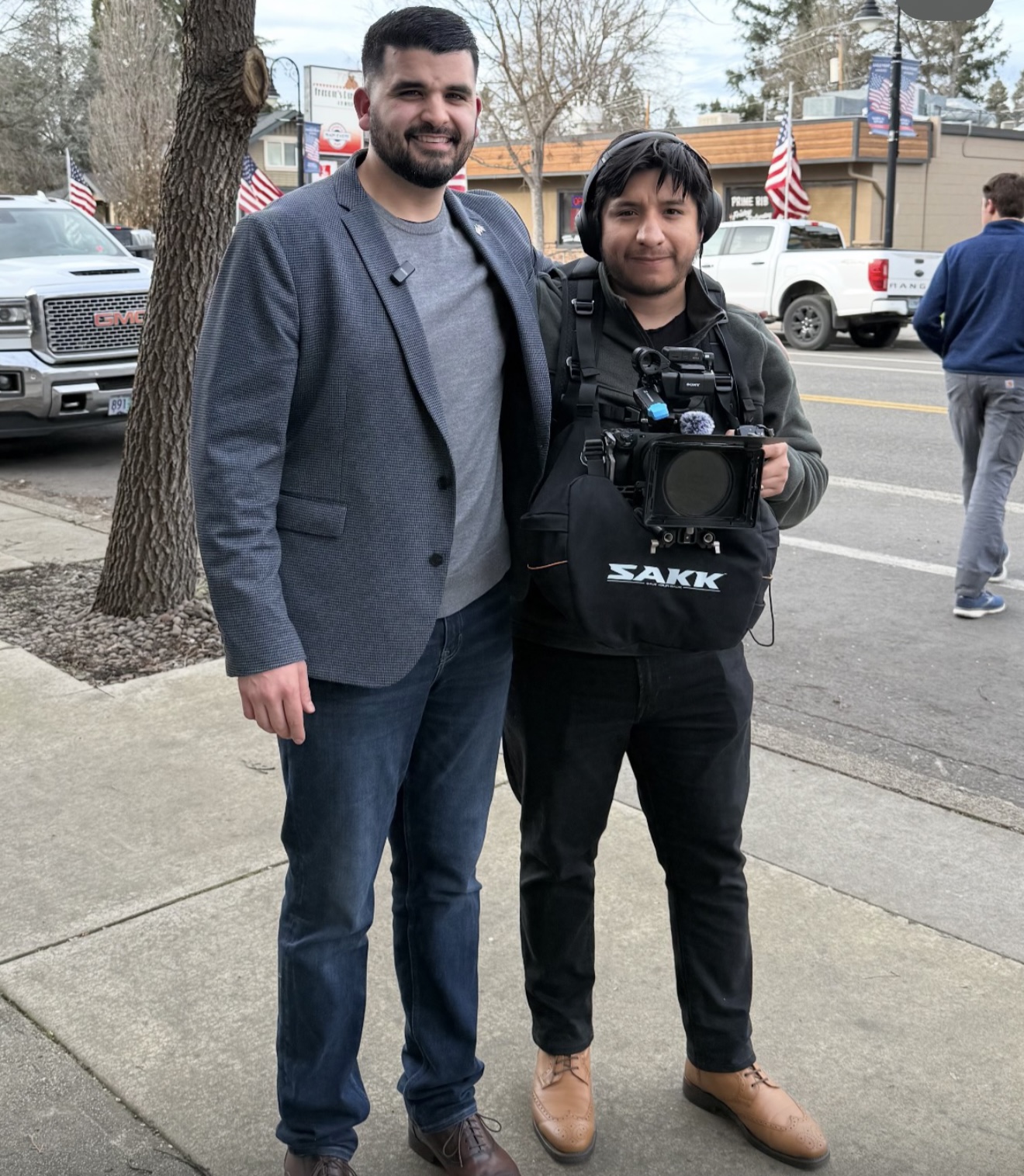Eleazar standing with a client on location