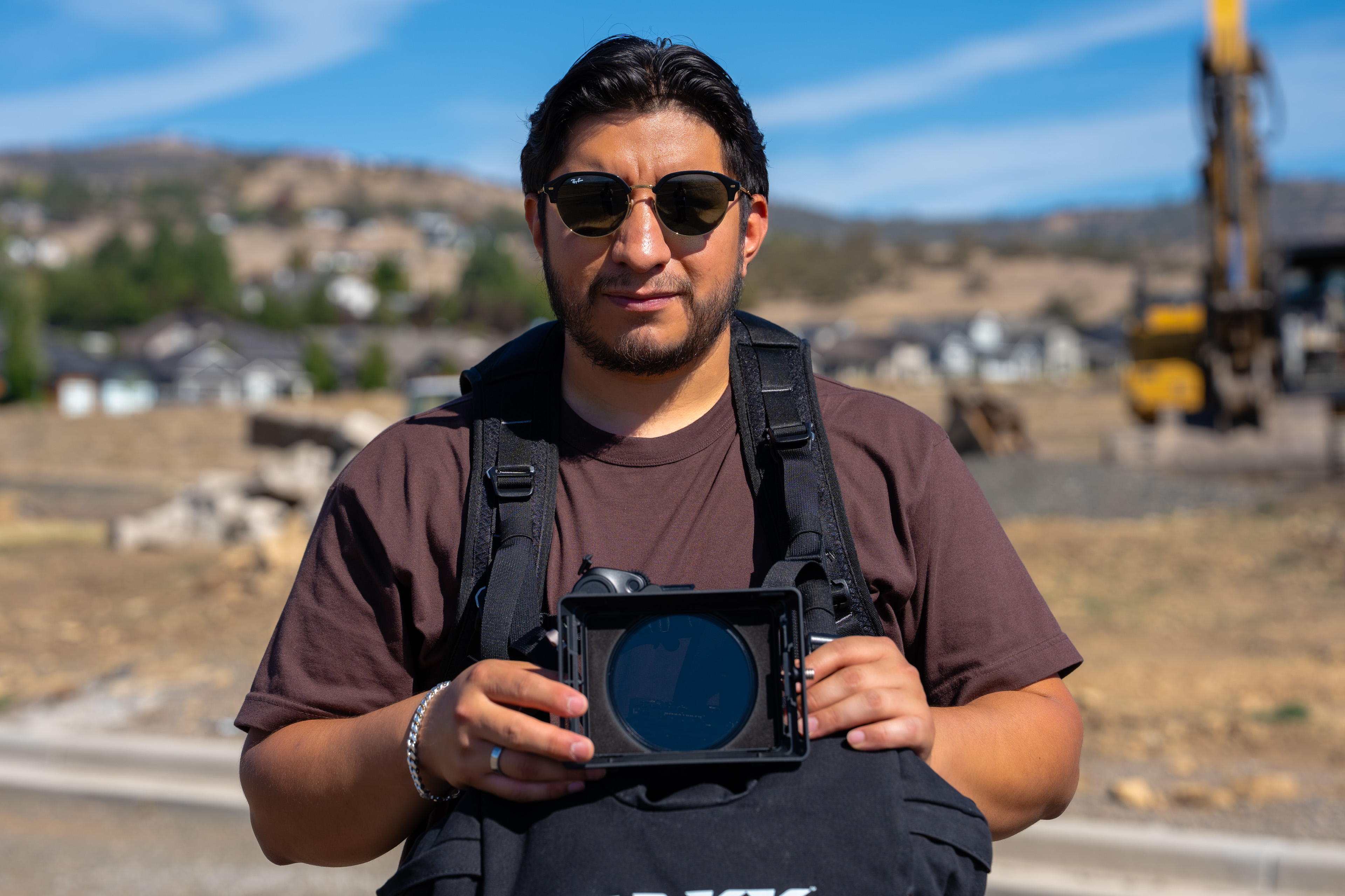 Eleazar Perez holding his camera on a jobsite